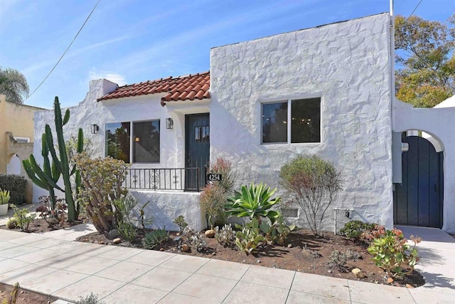 mediterranean / spanish-style house with a tiled roof and stucco siding