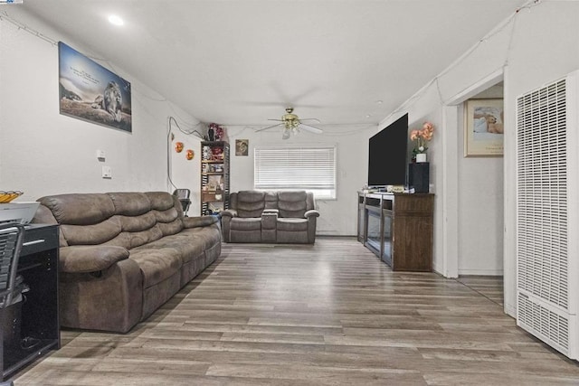 living room with ceiling fan and wood-type flooring