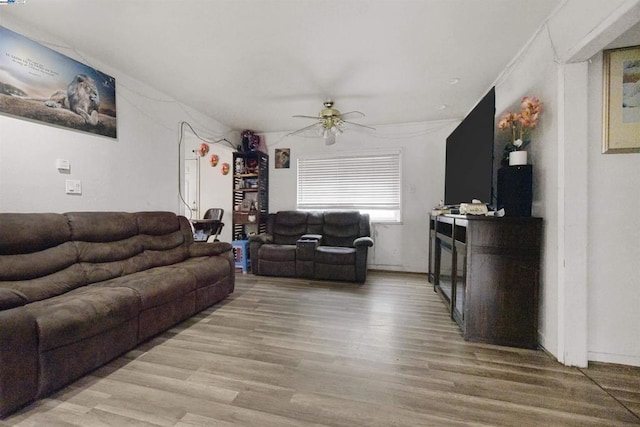 living room with crown molding, hardwood / wood-style floors, and ceiling fan