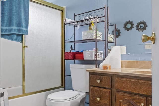 full bathroom with vanity, toilet, and combined bath / shower with glass door