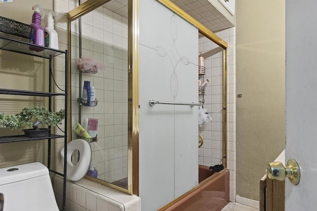 bathroom with enclosed tub / shower combo and toilet