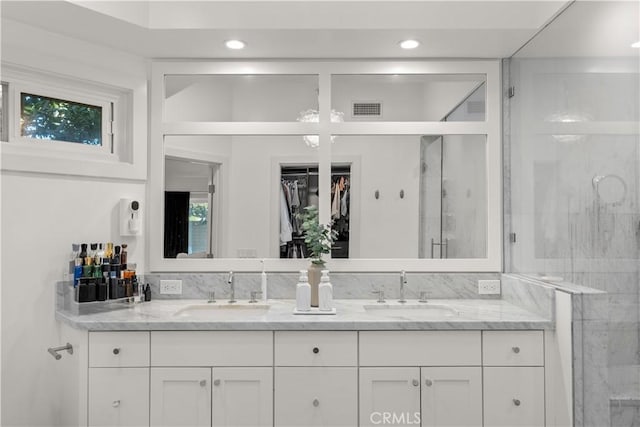 bathroom featuring vanity and a shower with shower door