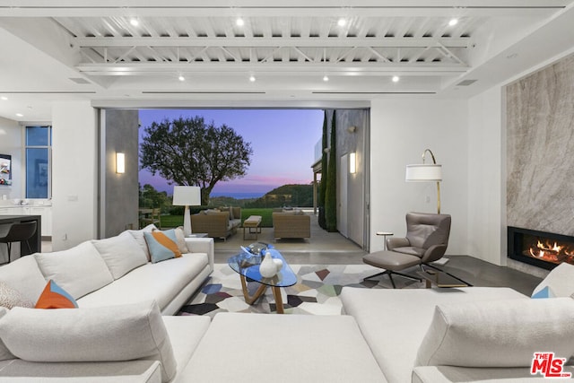 living room with rail lighting and a fireplace