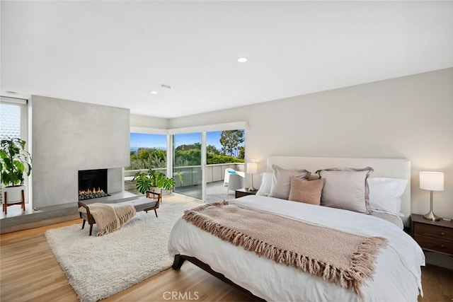 1900 Catalina St, Laguna Beach, CA 92651 - bedroom with access to exterior, a fireplace, multiple windows, and wood finished floors