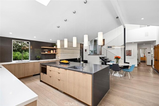 1900 Catalina St, Laguna Beach, CA 92651 - kitchen featuring modern cabinets, light wood-style flooring, light brown cabinetry, a sink, and a spacious island