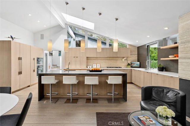 1900 Catalina St, Laguna Beach, CA 92651 - kitchen featuring light wood-style floors, modern cabinets, light brown cabinetry, a sink, and decorative backsplash