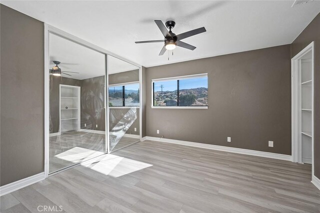 unfurnished bedroom with ceiling fan and light hardwood / wood-style floors