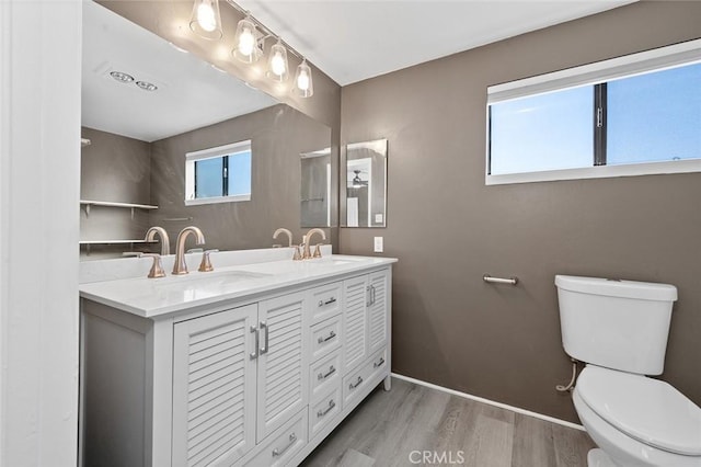 bathroom with vanity, hardwood / wood-style floors, and toilet