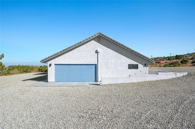 view of property exterior featuring a garage