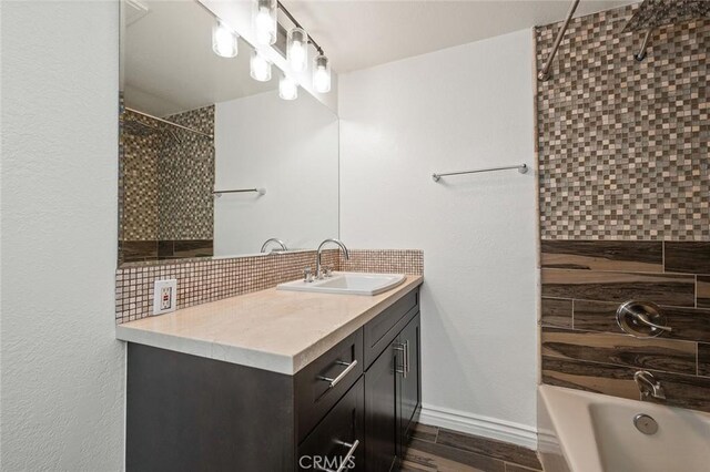 bathroom with vanity, tub / shower combination, and decorative backsplash