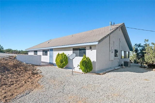 back of house featuring central AC