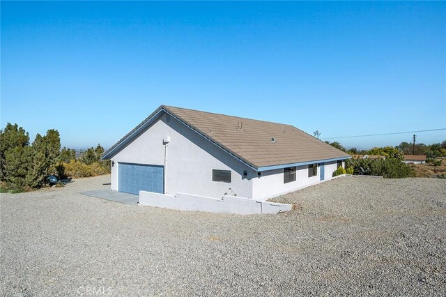 back of property featuring a garage