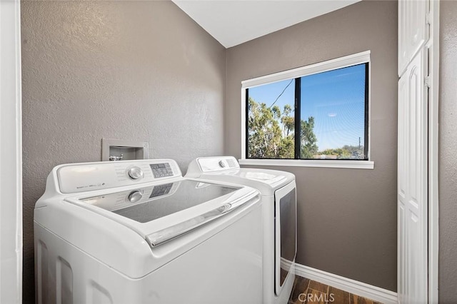 laundry area featuring separate washer and dryer and dark hardwood / wood-style flooring