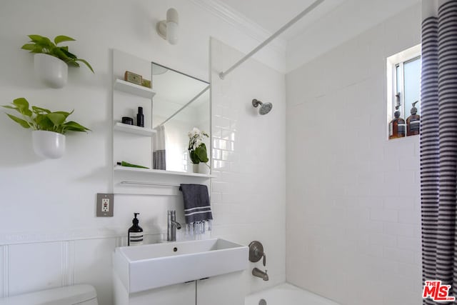 full bathroom featuring ornamental molding, sink, shower / bath combination with curtain, and toilet