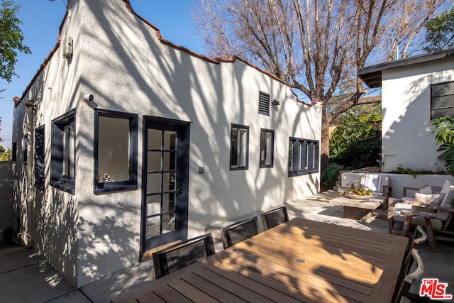 exterior space featuring an outdoor living space and a patio