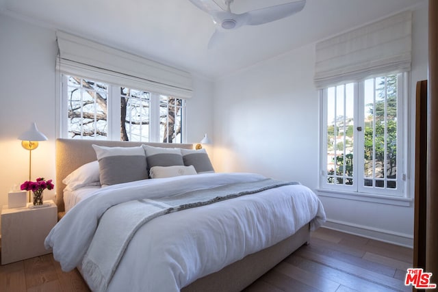 bedroom featuring crown molding, hardwood / wood-style floors, and ceiling fan