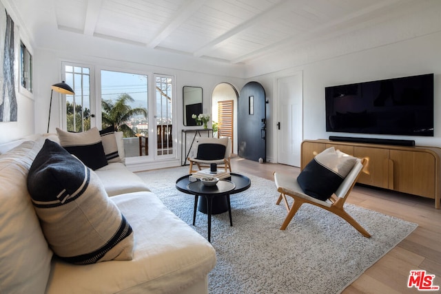 living room with beamed ceiling, light hardwood / wood-style floors, and wooden ceiling