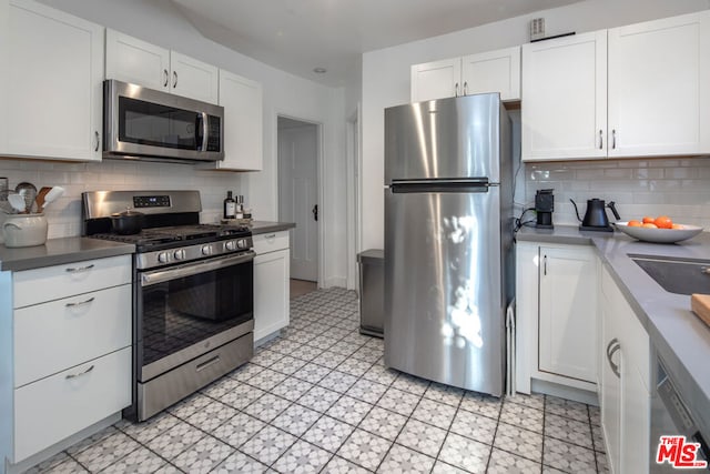 kitchen with white cabinetry, appliances with stainless steel finishes, and decorative backsplash