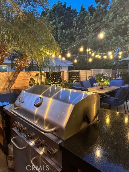 view of patio featuring fence and grilling area