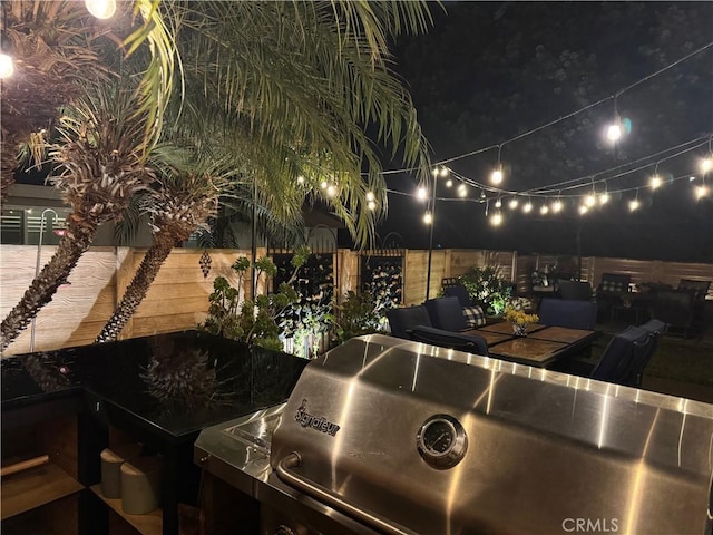 patio at twilight featuring fence