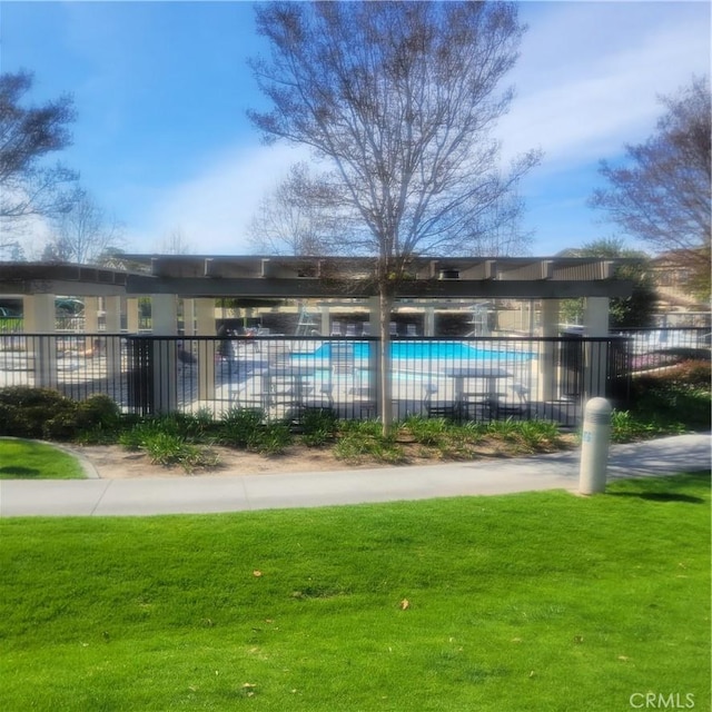 pool featuring a yard and fence