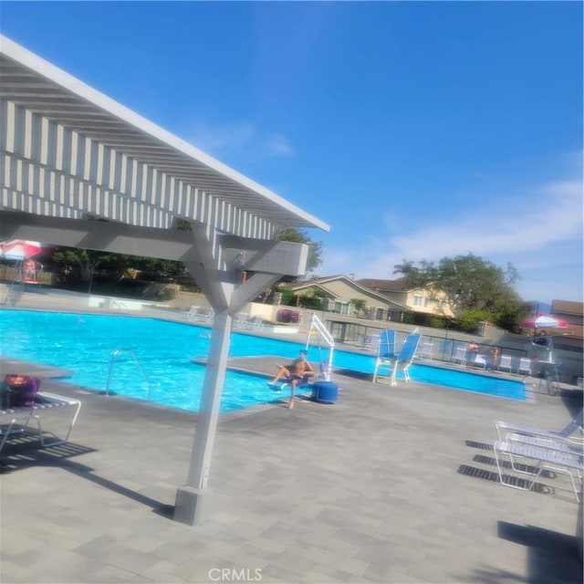 pool featuring a patio, fence, and a pergola