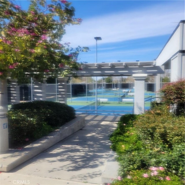 view of tennis court featuring fence