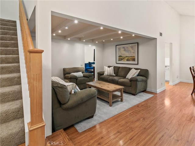 living area with visible vents, recessed lighting, light wood finished floors, baseboards, and stairs