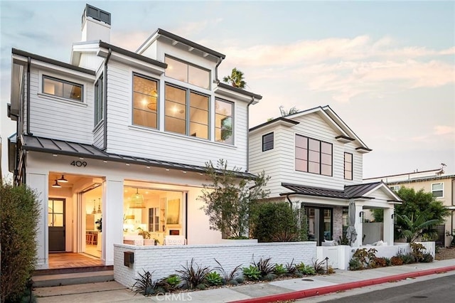 409 39th St, Newport Beach, CA 92663 - view of front of property with a standing seam roof, metal roof, and a chimney