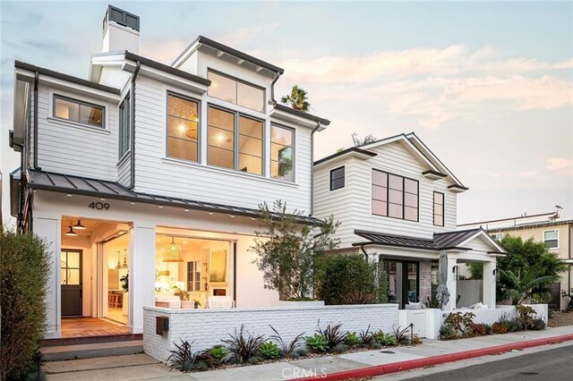 409 39th St, Newport Beach, CA 92663 - view of front of home featuring a standing seam roof, a metal roof, and a chimney