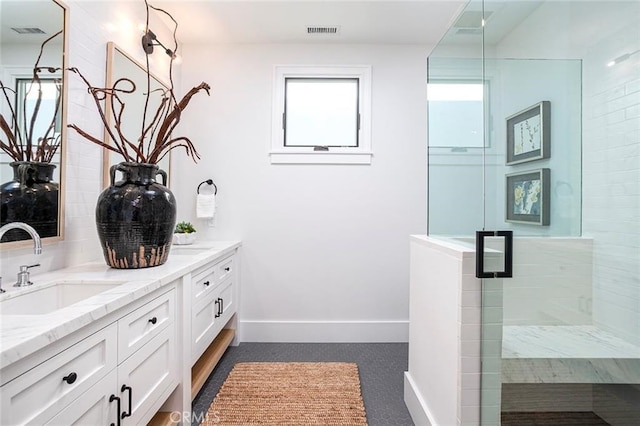409 39th St, Newport Beach, CA 92663 - bathroom featuring double vanity, a stall shower, and baseboards