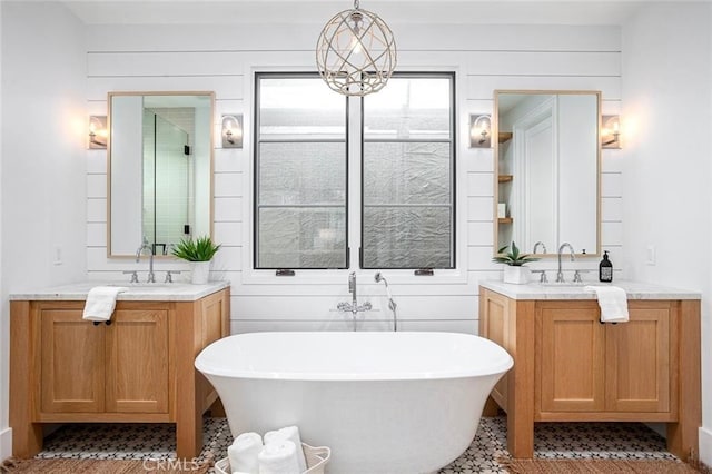 bathroom with vanity and a tub to relax in