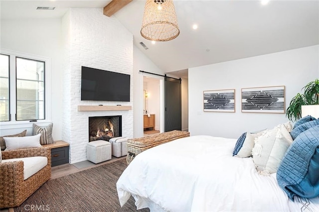 bedroom with a barn door, wood-type flooring, high vaulted ceiling, beamed ceiling, and a fireplace