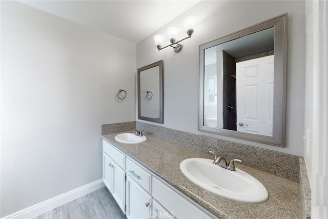 bathroom with vanity and wood-type flooring