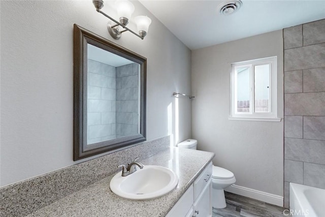 full bathroom featuring vanity, wood-type flooring, shower / washtub combination, and toilet