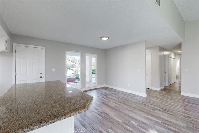 unfurnished living room featuring light wood-type flooring