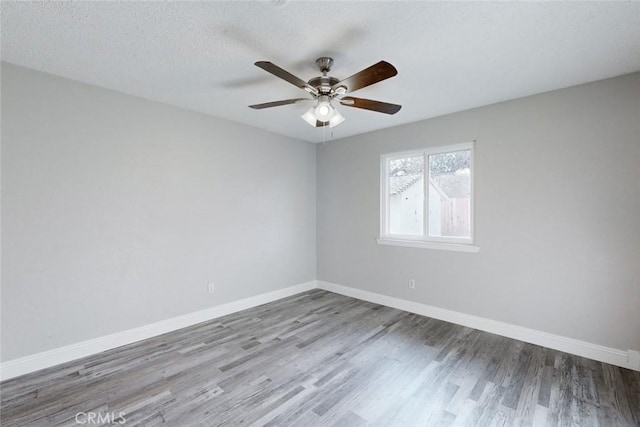 unfurnished room with hardwood / wood-style flooring, ceiling fan, and a textured ceiling