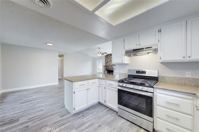 kitchen featuring white cabinetry, ceiling fan, kitchen peninsula, gas range, and light hardwood / wood-style flooring