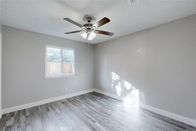 empty room featuring ceiling fan, light hardwood / wood-style floors, and a textured ceiling