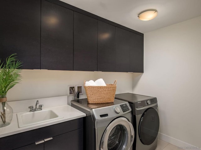 washroom featuring cabinets, sink, light tile patterned floors, and independent washer and dryer