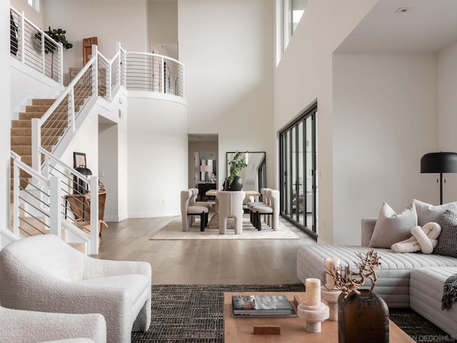 living room featuring a high ceiling and light wood-type flooring