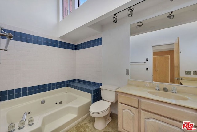 bathroom featuring vanity, a washtub, and toilet