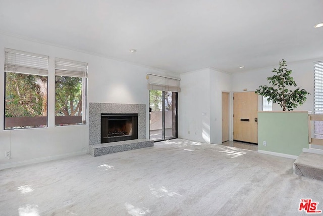 unfurnished living room with light carpet and crown molding