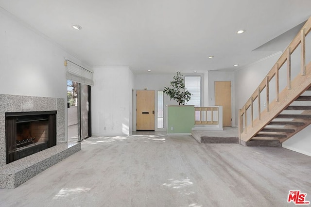 unfurnished living room with hardwood / wood-style flooring and crown molding