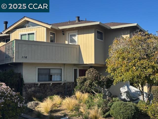 rear view of property with a balcony