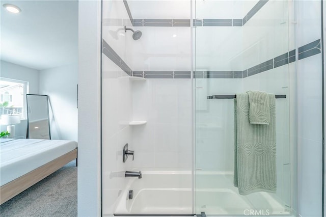 bathroom featuring bath / shower combo with glass door