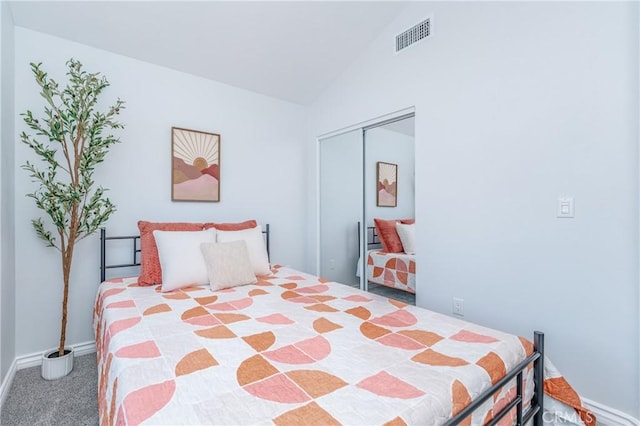 bedroom with lofted ceiling, carpet floors, and a closet