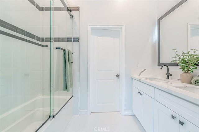 full bathroom with double vanity and a sink