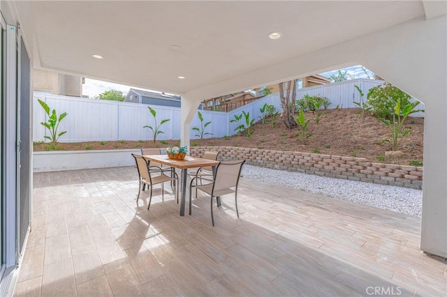 view of patio with a fenced backyard and outdoor dining space