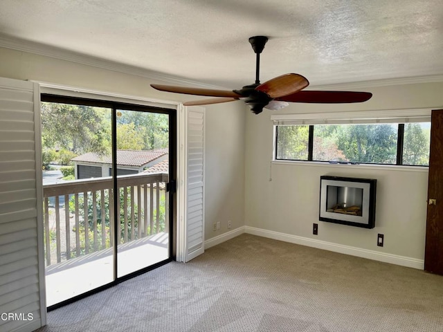 205 Pirie Rd Unit 64, Ojai, CA 93023 - spare room with ornamental molding, ceiling fan, carpet flooring, a textured ceiling, and a fireplace